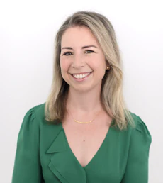 Professional woman in green blouse smiling against white background