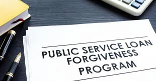 Public Service Loan Forgiveness Program document with pen and calculator
