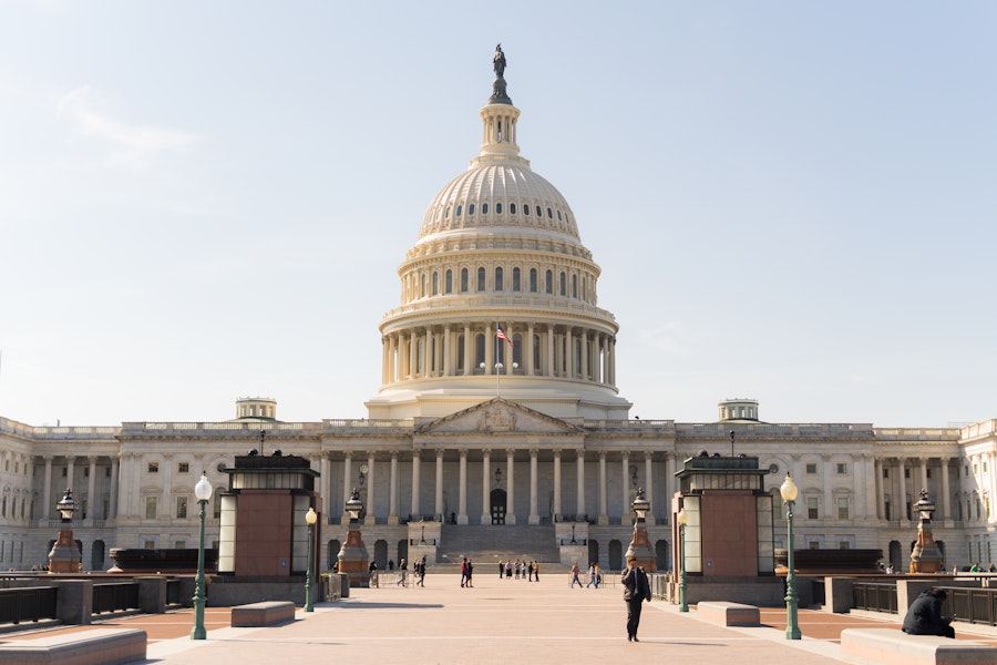 U.S. Capitol Building in Washington D.C. with clear sky and pedestrian walkway