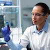 Researcher Biochemist Doctor Analyzing Transparent Vacutainer With Blood Working Microbiology Experiment Hospital Laboratory Biologist Woman Developing Medical Vaccine Using Biotechnology